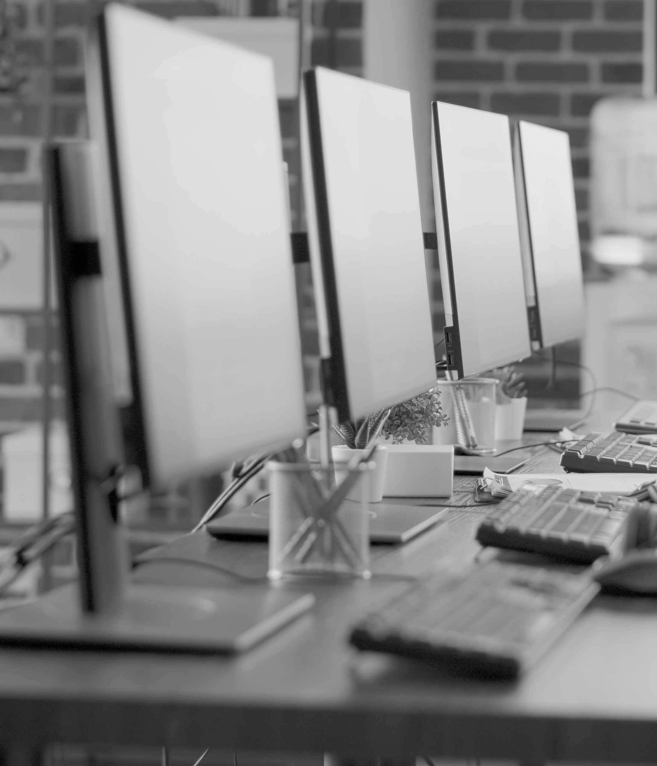 Nobody in empty call center workstation with computers and audio instruments. No people at customer service office desks with telecommunications technology, offering helpline assistance.